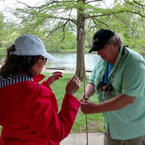 Man helps woman to fish