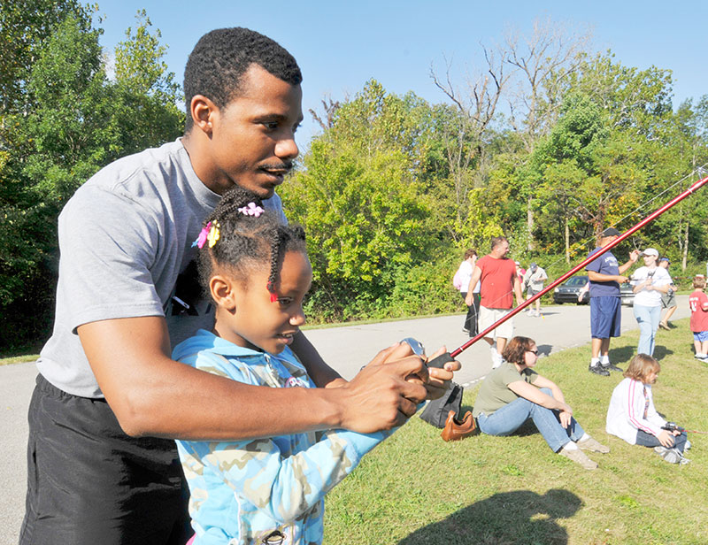 Man helping child to fish