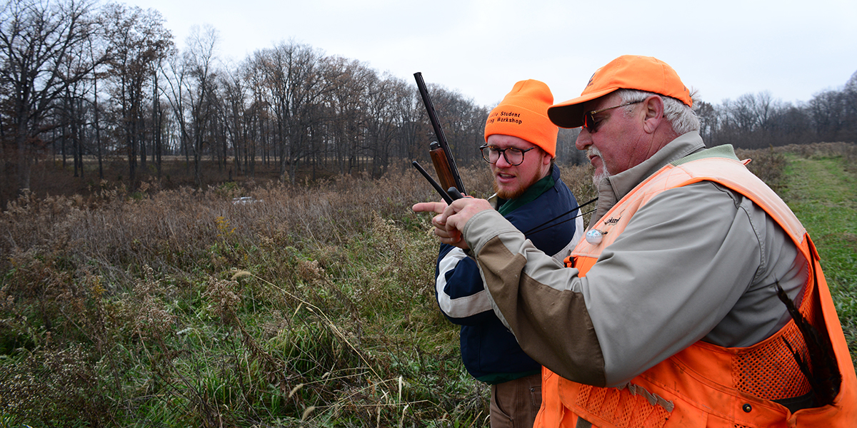 Two men learning to hunt