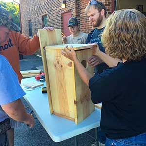 Volunteers building bird houses