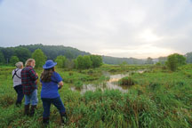 Stone Head Conservancy birders Jeff Riegel, Mike Kelley and Ann Maxwell count birds last July during a monthly survey in the preserve's Zimmerman Wetland.