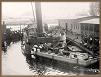 Historic picture of vessel at dock after being burned, view of vessel’s bow, 1911.