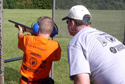 Young boy practices with a shotgun