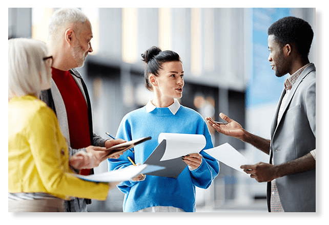 Group of people discussing a work project in a circle