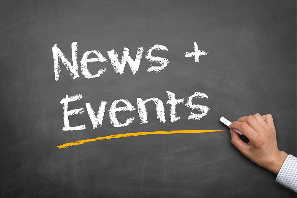 Hand Writing News and Events on a Chalkboard